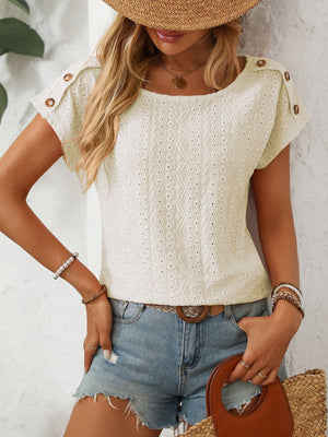 Cream eyelet knit t-shirt with shoulder button detail and short sleeves.