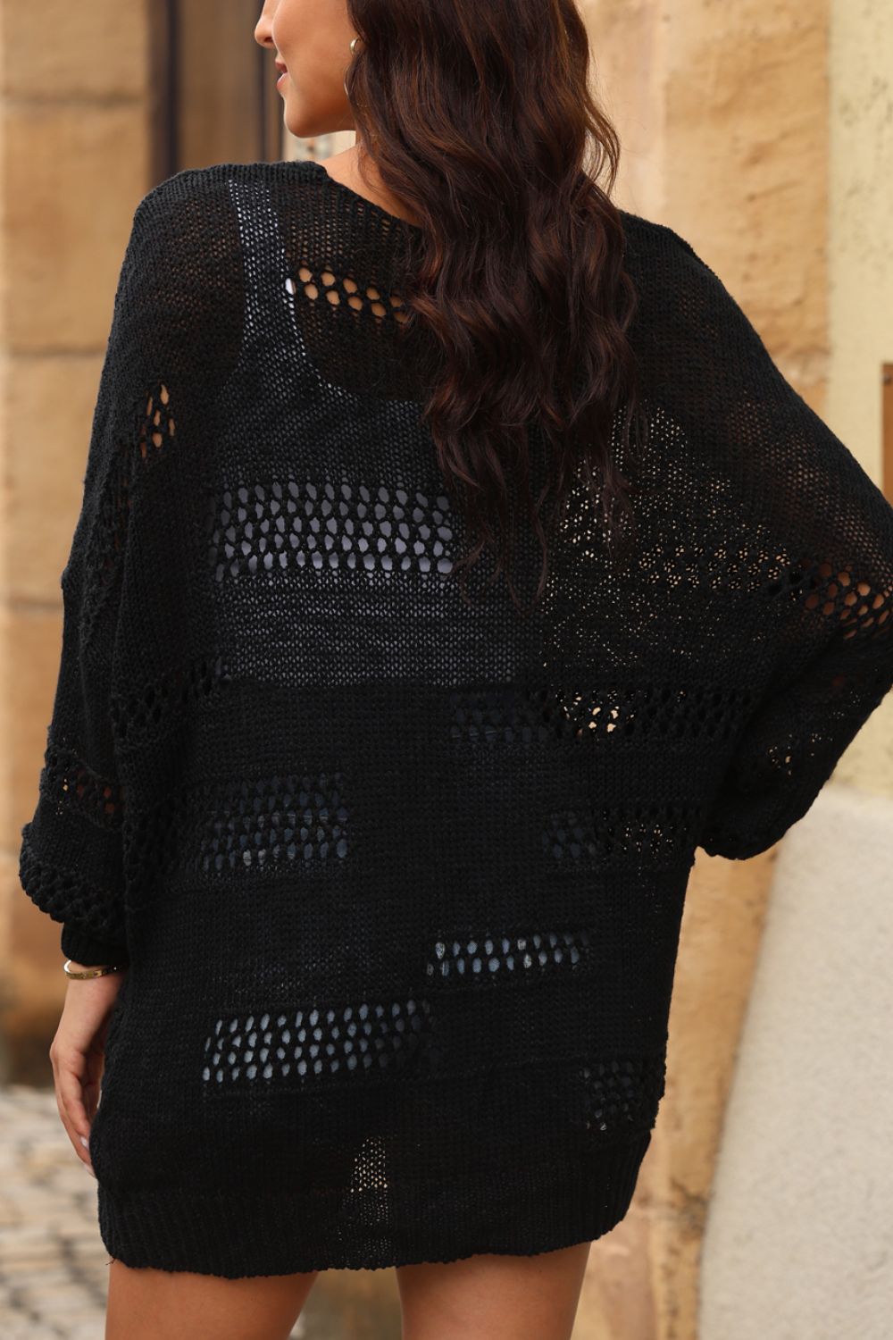 Black open-knit slouch cardigan with airy, distressed details and a relaxed fit.