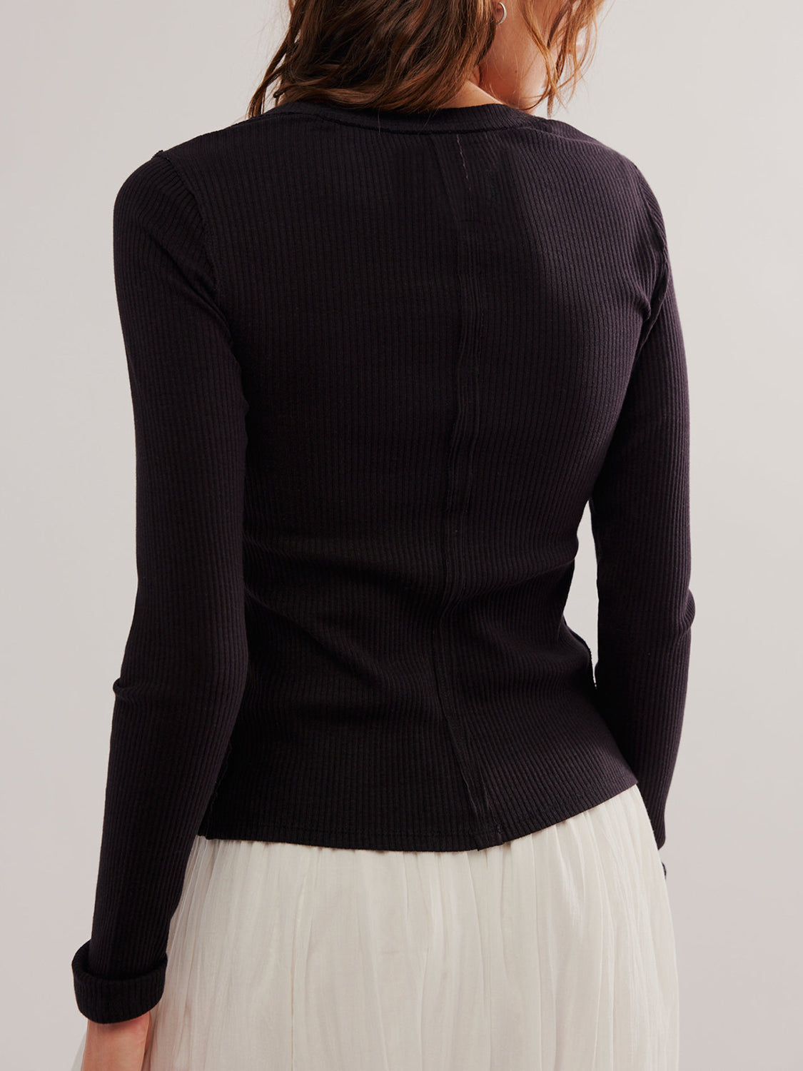 Black ribbed knit button-front slim fit top with long sleeves.