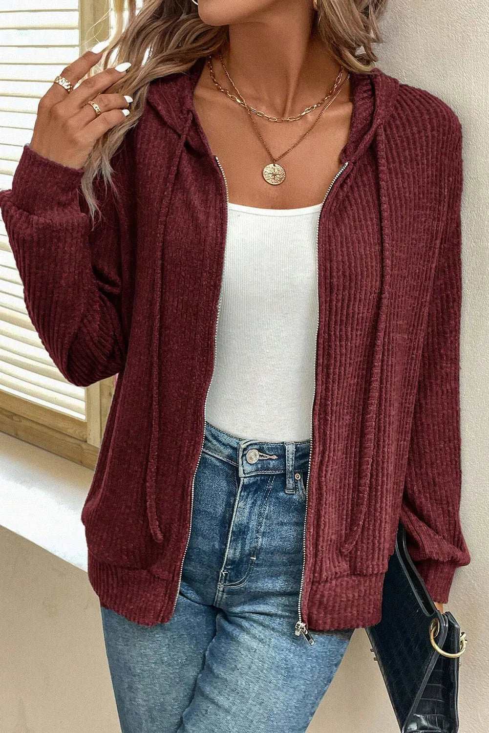 Burgundy textured ribbed knit zip-up hoodie with drawstring hood and pockets.