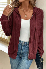 Burgundy textured ribbed knit zip-up hoodie with drawstring hood and pockets.