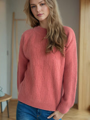 Textured knit raglan sleeve pullover in burnt coral with mock neck and diamond pattern.