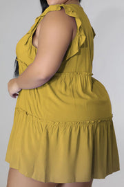 Tiered ruffle babydoll mini dress in mustard yellow with ruffled tiers and elastic waist.