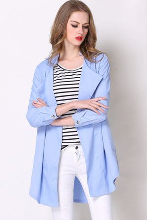 Light blue drape-front trench coat with shoulder detailing and buttoned cuffs.
