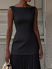 Black boat neck sleeveless maxi dress with pleated skirt detail.