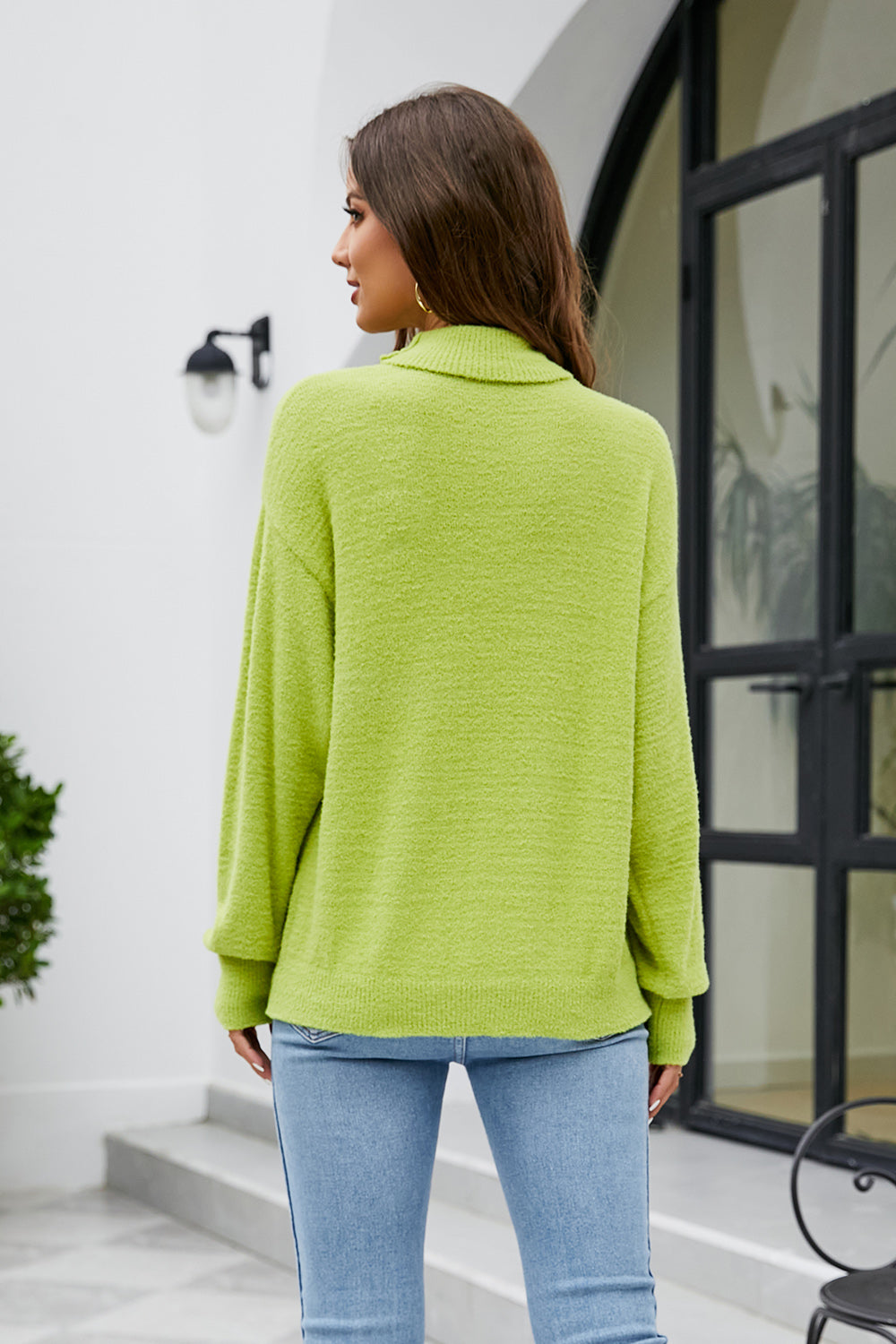 Textured turtleneck sweater in lime green with long sleeves.