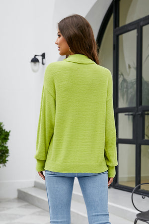 Textured turtleneck sweater in lime green with long sleeves.