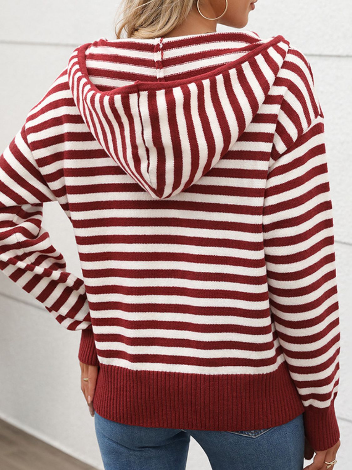 Burgundy striped zip-neck hooded knit sweater with ribbed cuffs and hem.