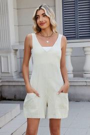 Beige linen romper with adjustable straps and front pockets.