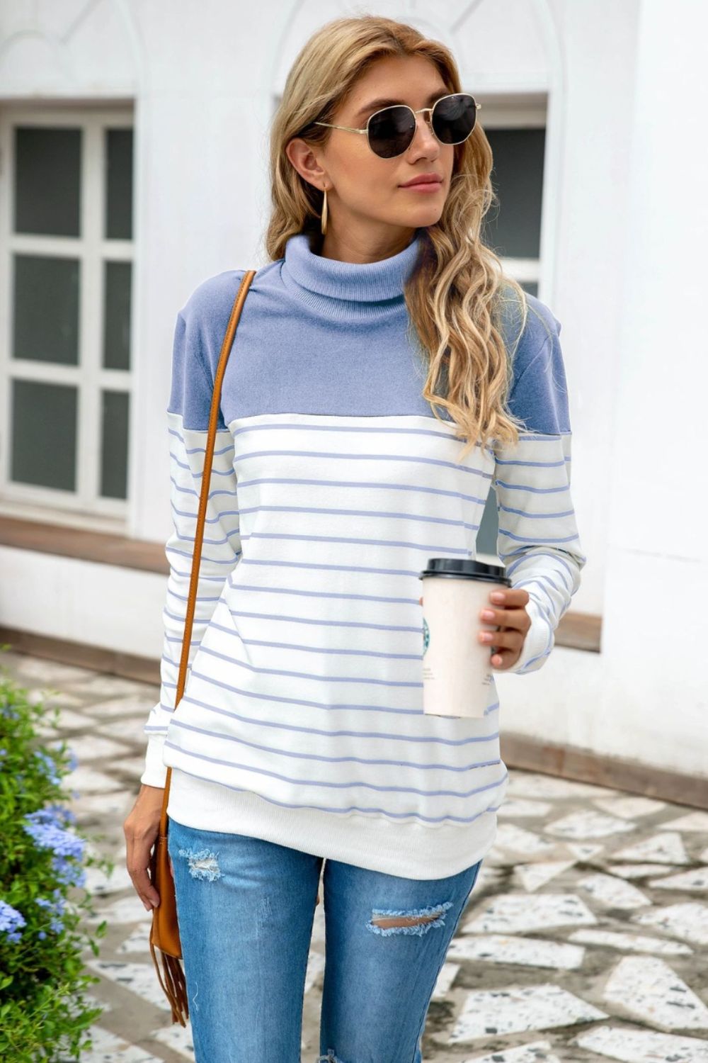 Colorblock stripe turtleneck knit sweater in light blue and white with a cowl neck and long sleeves.
