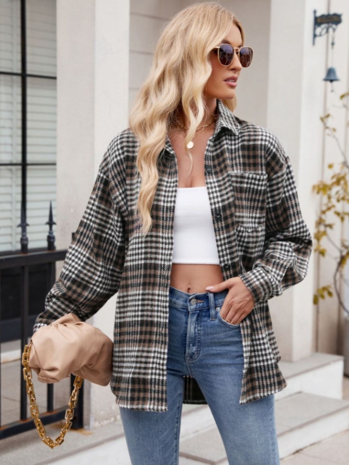Oversized plaid shirt jacket in brown, black, and white with a chest pocket.
