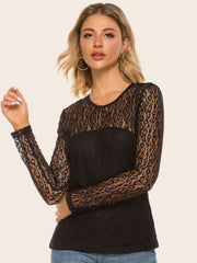 Black sheer leopard lace overlay blouse with long sleeves and a round neckline.