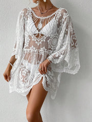 White embroidered crochet kaftan cover-up with bell sleeves and intricate lace details.