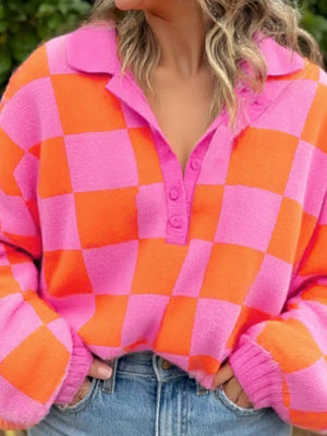Checkerboard button-up sweater in strawberry pink and orange with a collar and button placket.