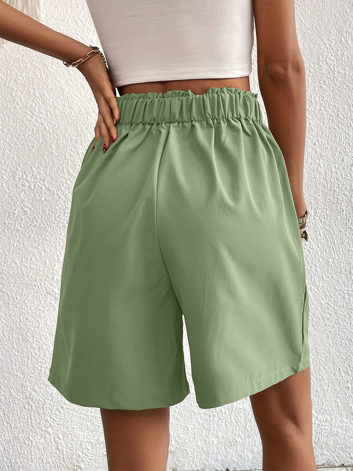 Pleated front bermuda shorts in light green with elastic waist