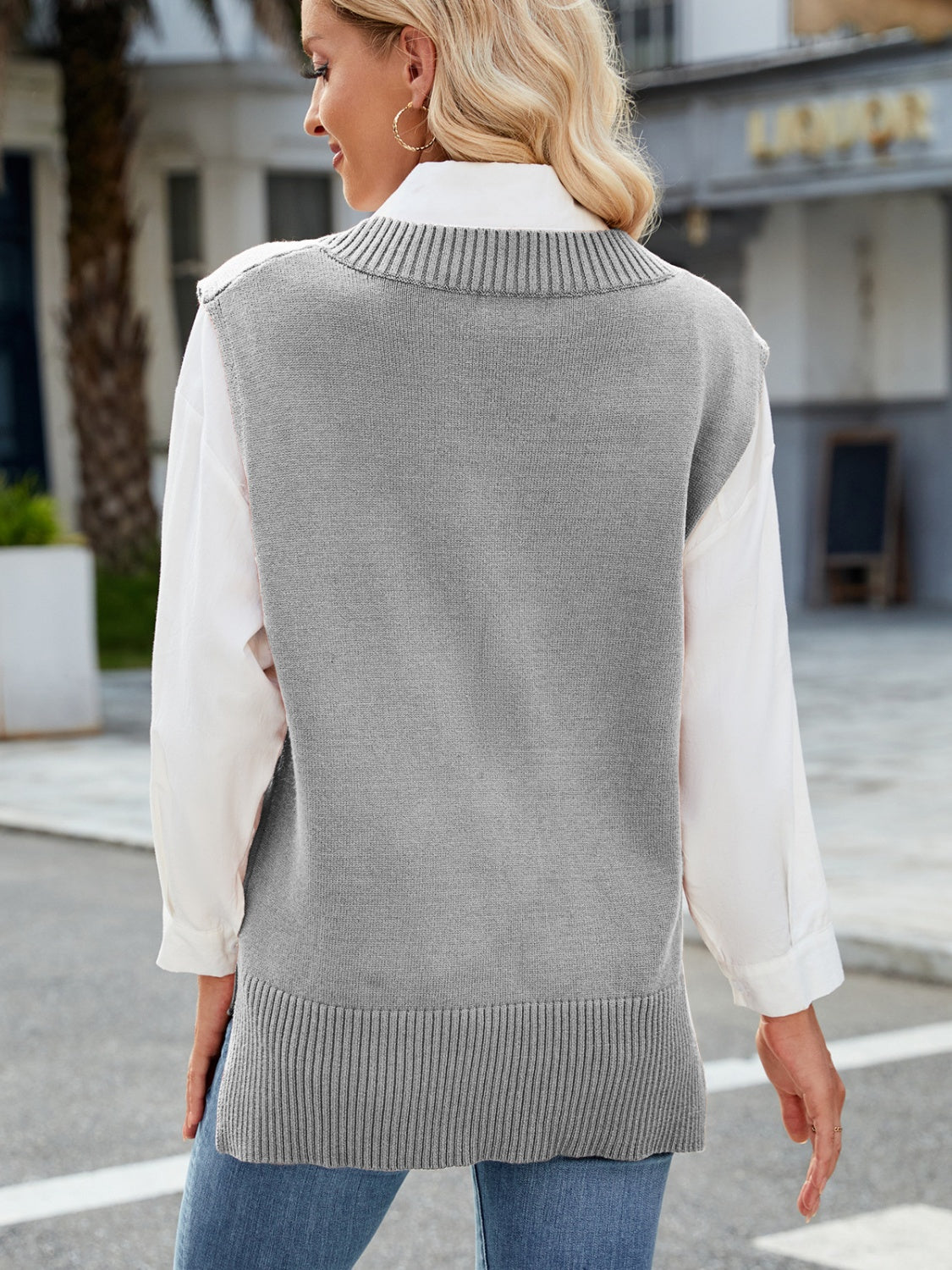 Gray ribbed knit V-neck sweater vest with a classic fit, styled over a white shirt.