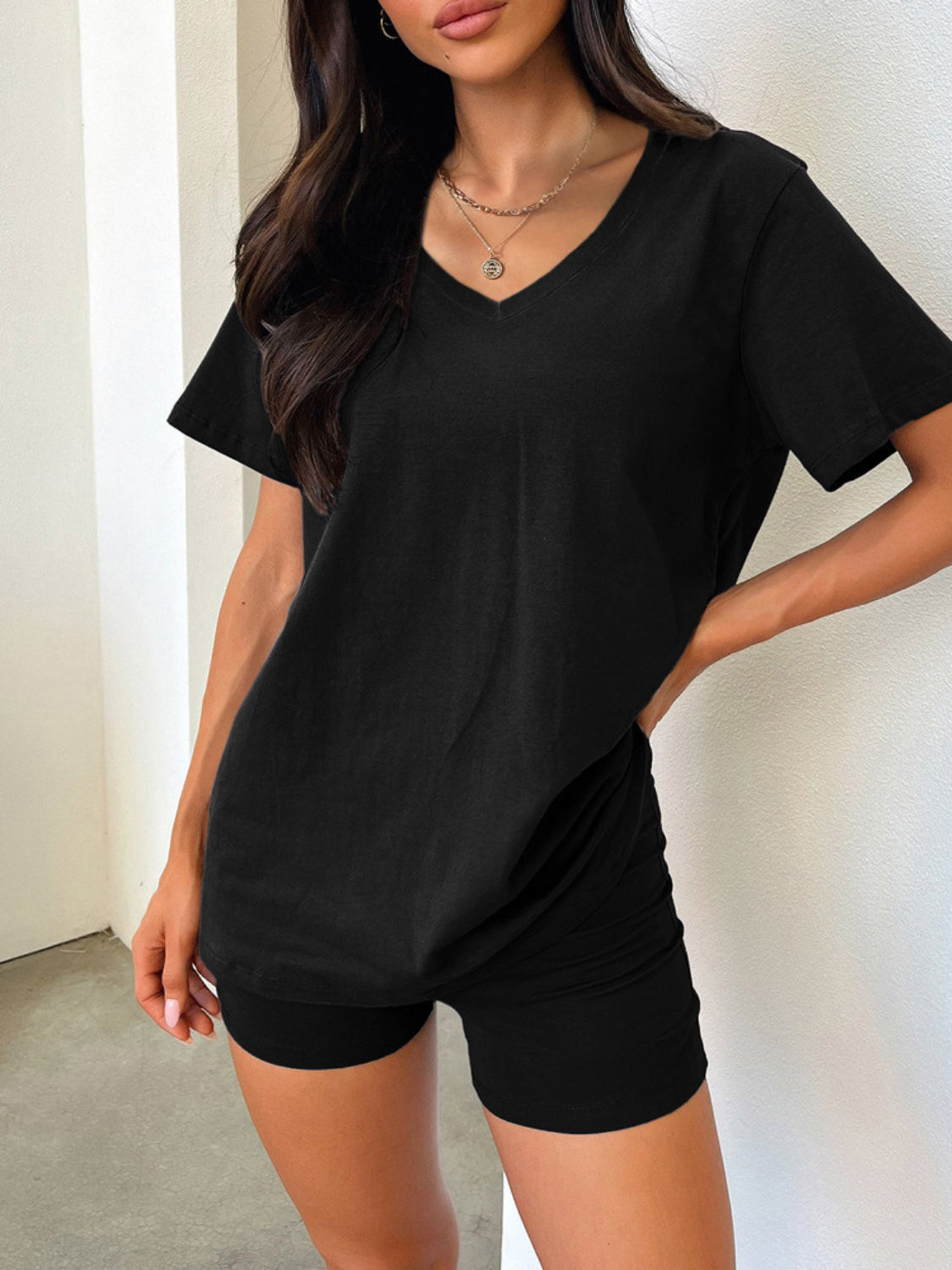 Black V-neck lounge set with relaxed fit t-shirt and fitted shorts.