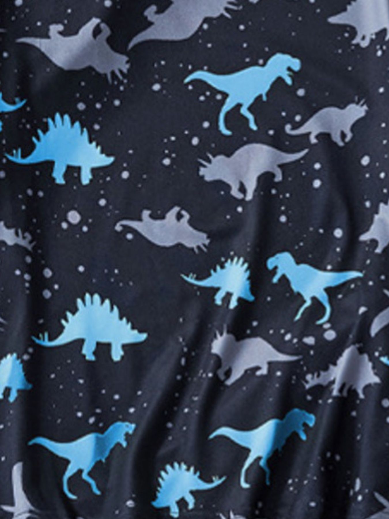 Toddler two-piece set with blue and grey dinosaur silhouettes on a dark background.