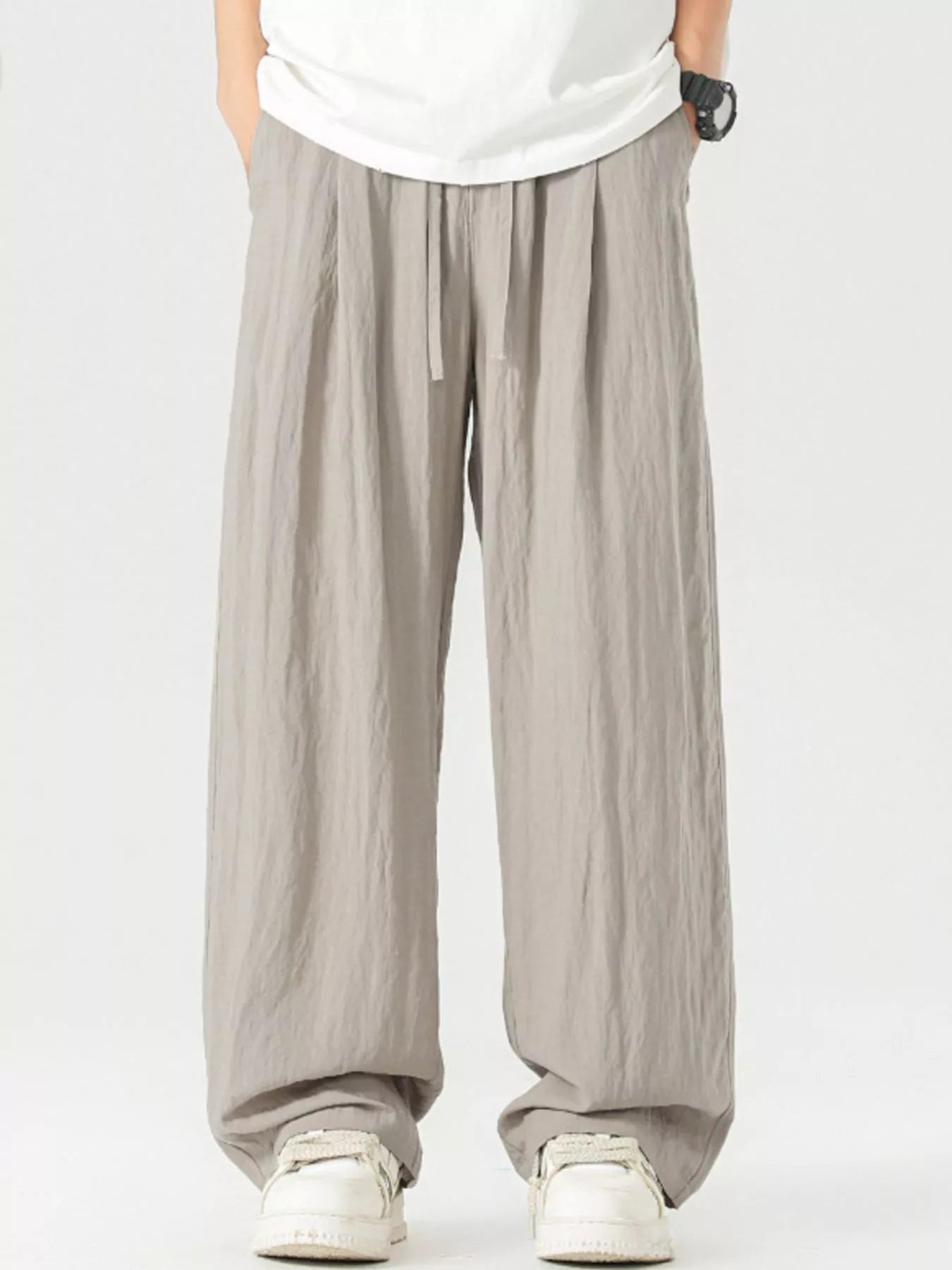 Lightweight wide-leg trousers in light gray with a drawstring waist and relaxed fit.