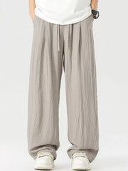 Lightweight wide-leg trousers in light gray with a drawstring waist and relaxed fit.