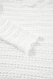 White textured long sleeve top with ruffle trim detail