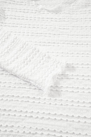 White textured long sleeve top with ruffle trim detail