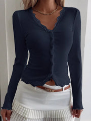 Navy ribbed long sleeve top with button front and lace trim neckline and hem.
