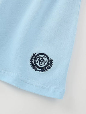 Light blue cotton polo shirt detail with embroidered crest logo