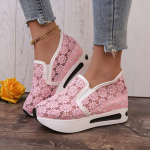 Pink floral lace slip-on sneakers with white trim and chunky sole.