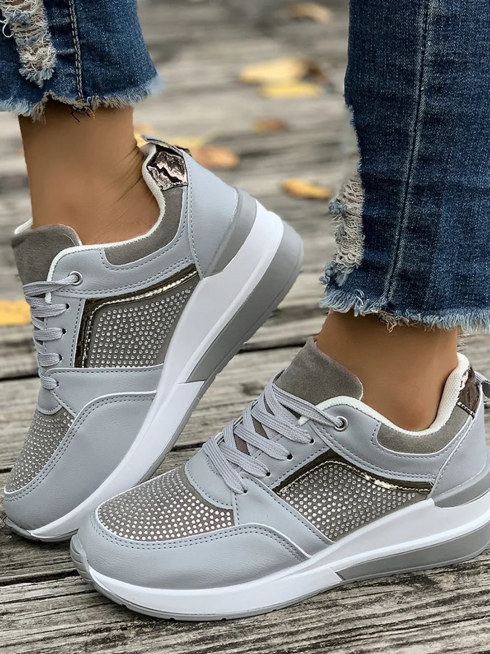 Light gray platform sneakers with gemstone panels and a metallic heel accent.