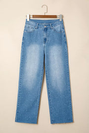 High-rise light wash denim jeans with subtle white stitch detail and raw hem.