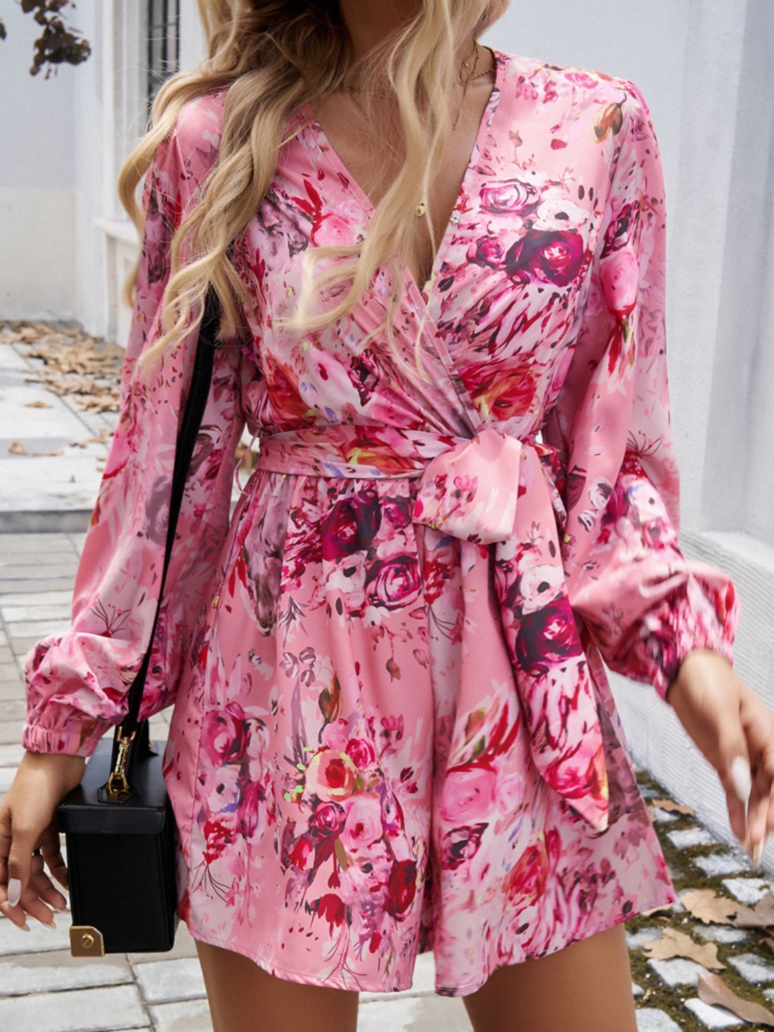 Floral wrap romper in Dusty Pink with blouson sleeves and a tie waist.