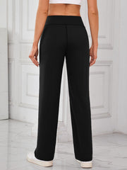Black wide-leg lounge trousers with patch pockets, featuring a relaxed fit and casual style.