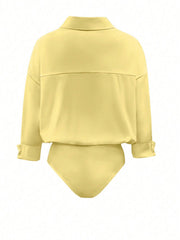 Yellow collared long sleeve bodysuit with cuffed sleeves and a button-down detail.