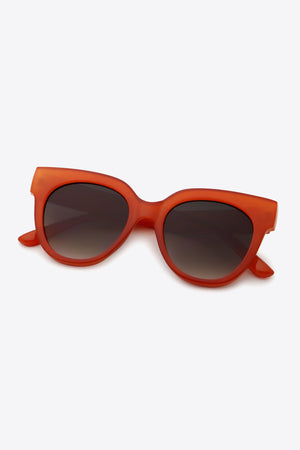 Sunset cat-eye sunglasses in deep red with gradient lenses.