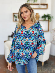 Prismatic ikat blouse with voluminous sleeves and a v-neck in green and sky blue.