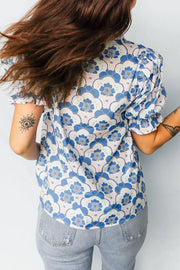 Playful floral puff sleeve blouse in blue and white with frill cuffs.