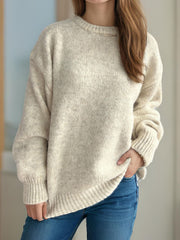 Beige oversized crewneck sweater with textured knit and ribbed cuffs and hem.