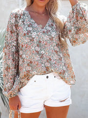 Floral print long sleeve maternity shirt with V-neck and balloon sleeves.