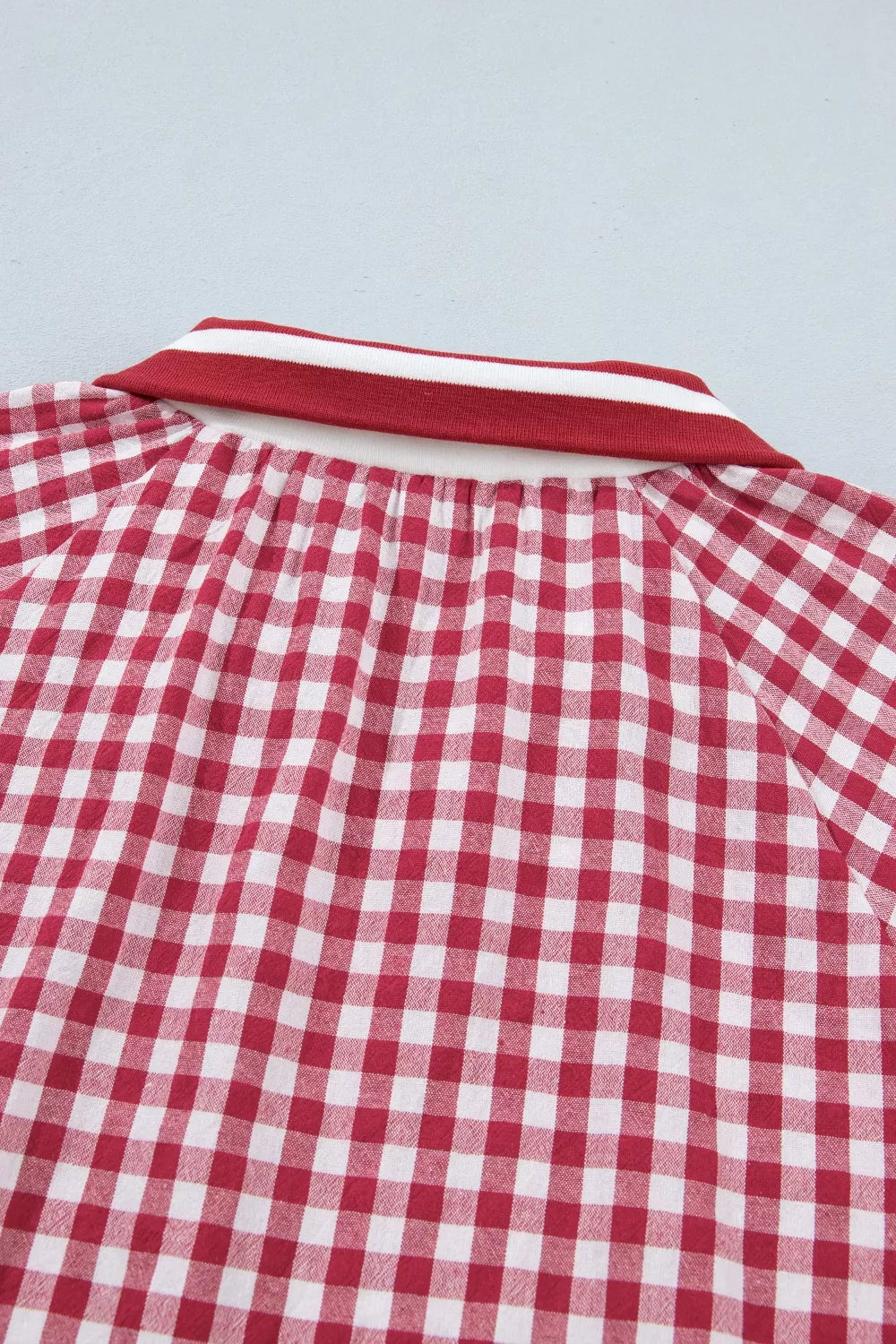 Red and white gingham cotton blend shirt with a striped collar detail.