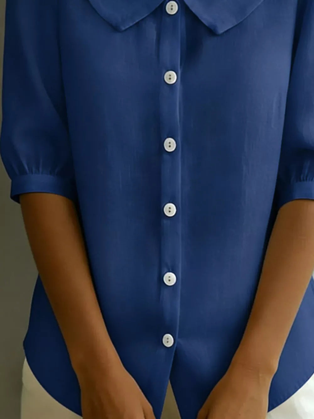 Peacock blue button-down shirt with Peter Pan collar and puff sleeves.