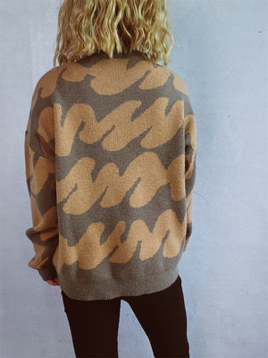 Graphic Wave Knit Sweater in camel and dark brown with a crew neck and long sleeves.