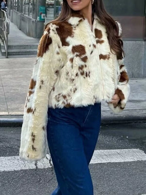 Cropped faux fur zip up jacket with brown and white cow print pattern.