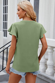 Matcha green flutter sleeve v-neck blouse with a relaxed fit.