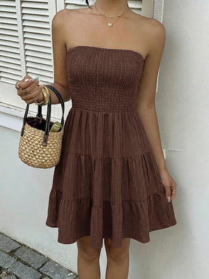 Gathered bodice tiered ruffle mini dress in dark brown, strapless, casual style.