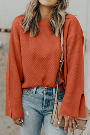 Textured knit sweater in ochre with slit sleeves and crew neck.