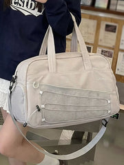 Grey nylon travel bag with mesh pockets and bungee cord detail.