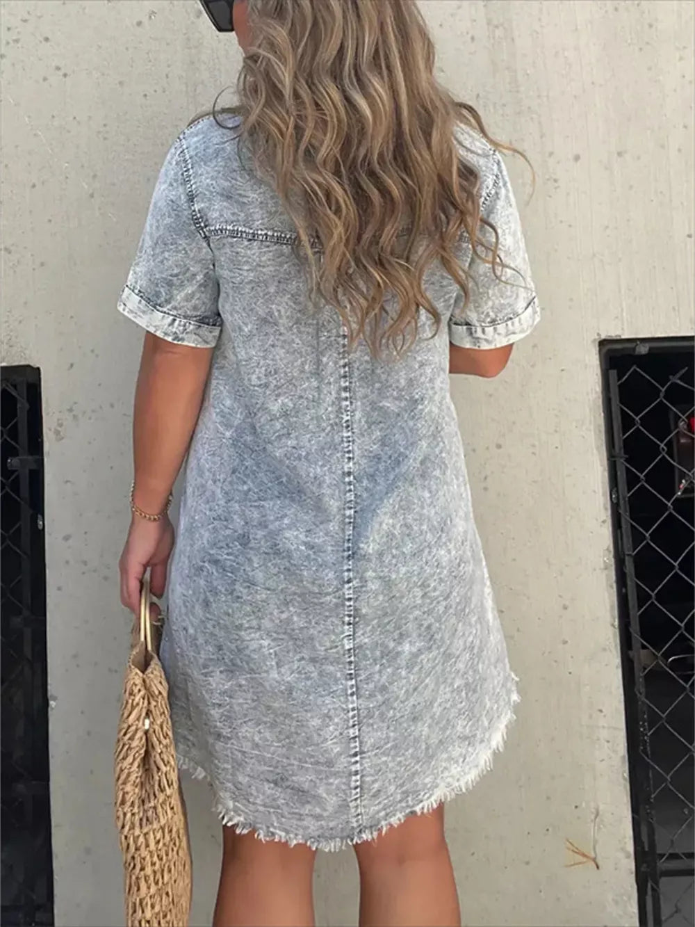 Grey denim short sleeve dress with frayed hem and a relaxed fit.