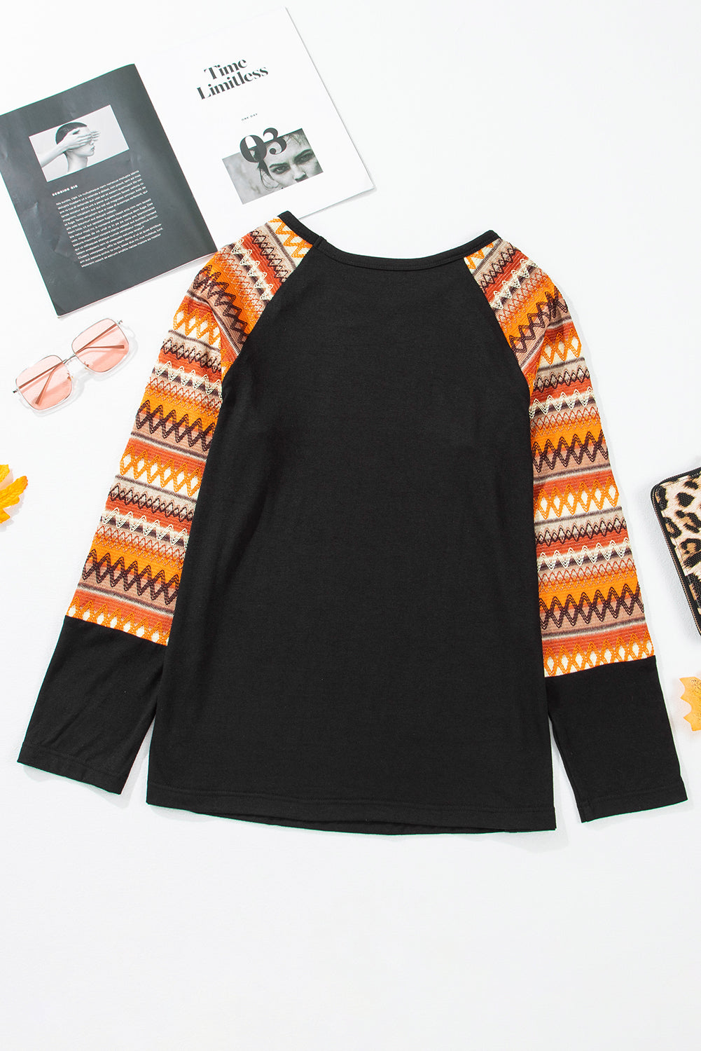 Black raglan tee with colorful Aztec print sleeves and crew neck.
