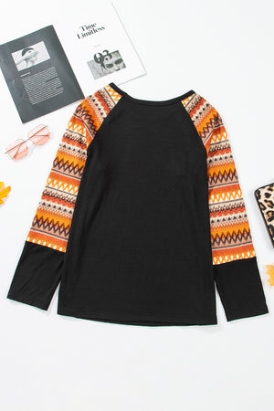 Black raglan tee with colorful Aztec print sleeves and crew neck.